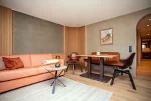 a living room with a couch and a table at Berghotel Schlossanger Alp in Pfronten