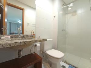 a bathroom with a sink and a toilet and a shower at AP Vista Panorâmica da Praia in Guarapari +12 photos