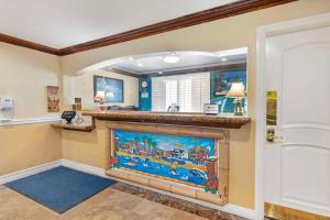 a living room with a fireplace in a house at Best Western Harbour Inn & Suites Huntington - Sunset Beach in Huntington Beach