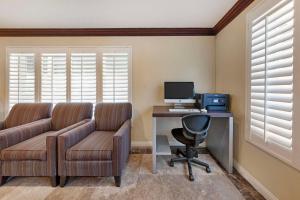 an office with a couch and a desk with a computer at Best Western Harbour Inn & Suites Huntington - Sunset Beach in Huntington Beach
