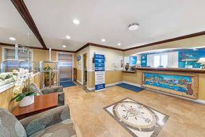 a living room with a large clock in the middle at Best Western Harbour Inn & Suites Huntington - Sunset Beach in Huntington Beach