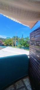 a room with a view of the ocean from a balcony at Hostel Vento Leste in Bombinhas