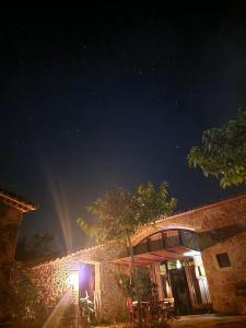 a building with a tree in front of it at night at El Racó dels Mussols 1 in Canet de Adri