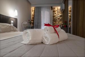a pile of towels sitting on top of a bed at Taormina charming rooms in Taormina