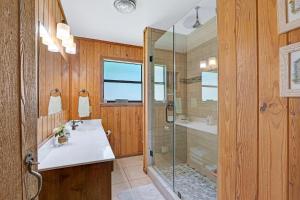 a bathroom with a glass shower and a sink at River Haven in Fourth Crossing +40 photos