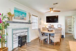 a dining room with a fireplace and a table and chairs at Less Than 1 Mi to Beach Family-Friendly Port St Joe Home in Port Saint Joe