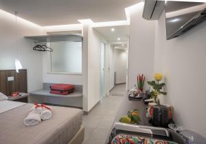 a hotel room with a bed and a window at Taormina charming rooms in Taormina