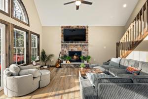 a living room with a couch and a fireplace at Lakeview Sunset Heaven Waterfront Escape Private Dock Firepit Game Room New Construction in Blakeslee