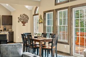 a dining room with a table and chairs at Lakeview Sunset Heaven Waterfront Escape Private Dock Firepit Game Room New Construction in Blakeslee