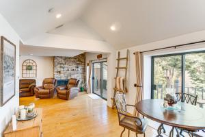 a living room with a table and chairs at Central Condo with Water Views in Lake Arrowhead! in Lake Arrowhead
