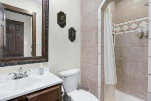 a bathroom with a sink and a toilet and a shower at Clutter Falls Retreat - Main House in New Braunfels +34 photos