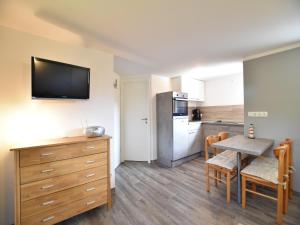 a small kitchen with a table and a dining room at Ground-Floor Getaway with Garden in Insel Poel