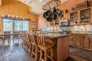 a kitchen with a large island with wooden cabinets at XXL Snowcreek #747 - 5 Bedroom 4 Bathroom Sleeps 12 Pet Friendly, Amazing Mountain Views in Mammoth Lakes