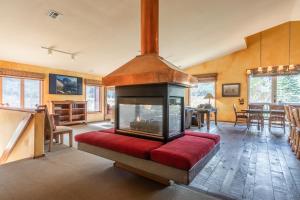 a living room with a fireplace and a red couch at XXL Snowcreek #747 - 5 Bedroom 4 Bathroom Sleeps 12 Pet Friendly, Amazing Mountain Views in Mammoth Lakes