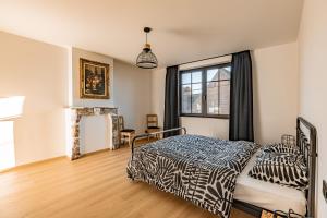 a bedroom with a bed and a window at Villa Victoire in Heers