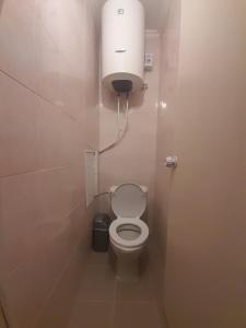 a small bathroom with a toilet in a stall at Traian Apartment in Chişinău