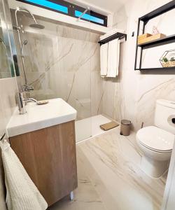 a bathroom with a sink and a toilet at Casa do Zimbro in Troia +21 photos