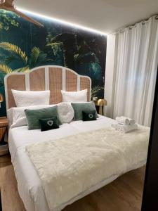 a bedroom with a large white bed with green pillows at BILBAO NORTH SHORE APARTMENTS 6 in Bilbao +28 photos