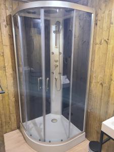 a shower with a glass enclosure in a bathroom at Maison idéale pour 2 personnes, garage clos et Wifi in Beauvoir-sur-Niort