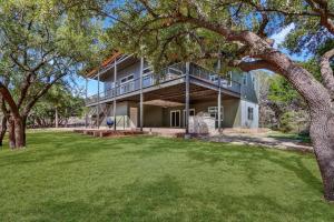 an exterior view of a house with a large yard at River Road Retreat in Wimberley