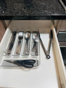 a tray of utensils in a sink in a kitchen at Home Away from Home number 2 in Roodepoort