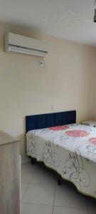 a bedroom with a bed in a room at Apartamento 202 Bombinhas in Bombinhas