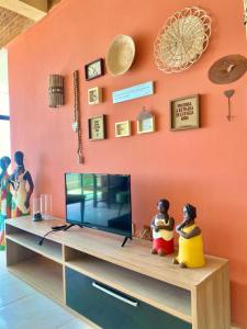 two rubber ducks sitting on top of a entertainment center at O De Casa in Japaratinga