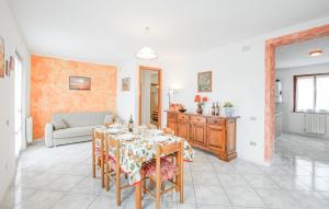 a dining room with a table and a couch at Cozy Apartment In Castiglione Del Lago in Castiglione del Lago