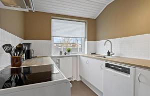 a kitchen with white appliances and a window at 2 Bedroom Stunning Home In Grenaa in Grenå