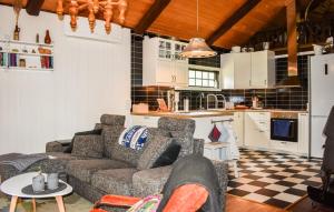a living room with a couch and a kitchen at 3 Bedroom Amazing Home In Ronneby in Ronneby
