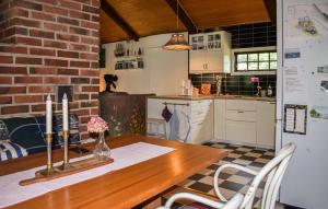 a kitchen with a wooden table with two candles on it at 3 Bedroom Amazing Home In Ronneby in Ronneby