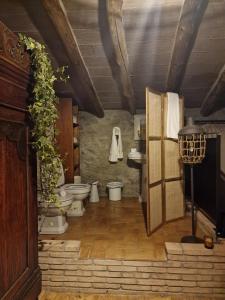 a bathroom with toilets and a sink in a room at El Racó dels Mussols 1 in Canet de Adri