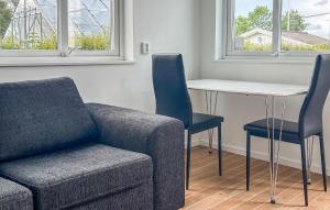 a living room with a couch and a table and chairs at Gorgeous Home In Landvetter in Landvetter