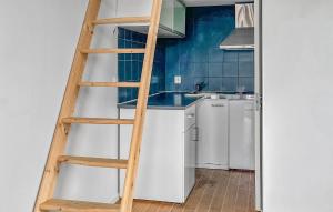 a ladder in a kitchen with a sink and a refrigerator at Gorgeous Home In Landvetter in Landvetter +2 photos