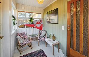 a small porch with two chairs and a table at 3 Bedroom Cozy Home In Skjærhalden in Skjærhollen