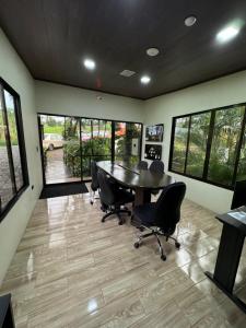 a conference room with a table and chairs in it at Contenedores Boutique Hotel in Platanal