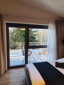 Postel nebo postele na pokoji v ubytování Evergreen Tále Apartments
