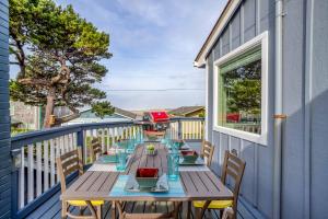 a table on a balcony with a view of the ocean at The Turtles Nest in Waldport
