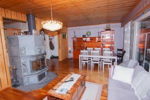 a living room with a fireplace and a dining room at Kent's Lodge in Herrefors