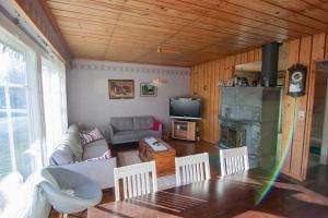 a living room with a table and a couch and a fireplace at Kent's Lodge in Herrefors