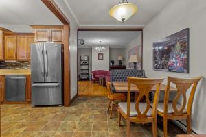 a kitchen and dining room with a stainless steel refrigerator at Chez Michele 3BR Parking Yard in St. John's