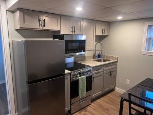 a kitchen with a stainless steel refrigerator and a sink at Private Penthouse Studio in Providence +6 photos