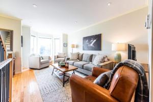 a living room with a couch and a table at Harbour View Hitch 2BR w Parking & Deck in St. John's