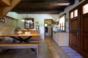 a dining room with a table and a kitchen at Oazena , Authentic house in peaceful village in Selnica