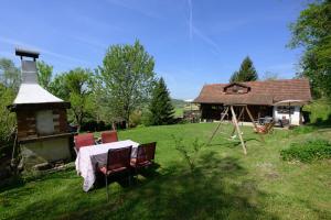 a house with a table and chairs in a yard at Oazena , Authentic house in peaceful village in Selnica