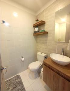 a bathroom with a toilet and a sink at AH/Loft con Alexa, Parking, Coworking, Usaquén in Bogotá