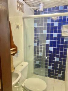 a bathroom with a toilet and a glass shower at O De Casa in Japaratinga +23 photos