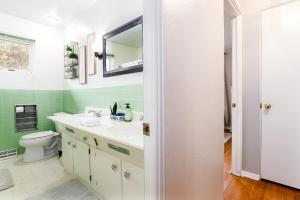 a bathroom with a white sink and a mirror at Legends Landing Home Close To ND in South Bend +25 photos