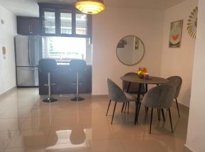 a kitchen and dining room with a table and chairs at Santuario Tropical at Marino Paradise in La Puntica de Juan Dolio