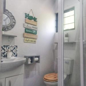 a bathroom with a toilet and a sink at Highview Lodge in Gillitts-Emberton +29 photos